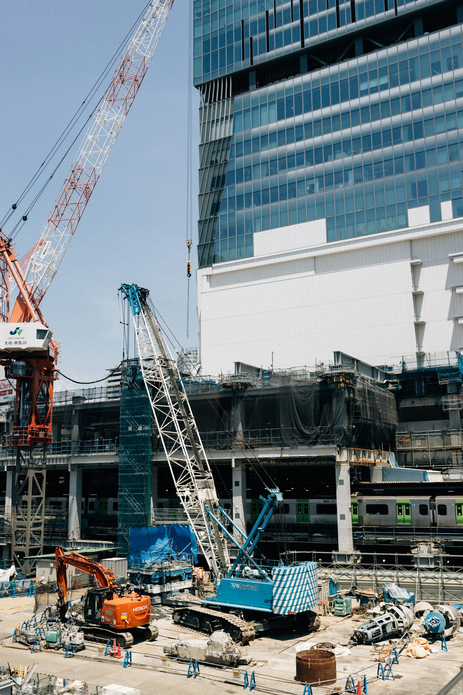 High-rise building under construction with tower cranes, representing a large-scale AEC project
